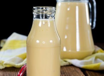 ZUCCHINI MILK IN PITCHERS ON WOODEN TABLE.