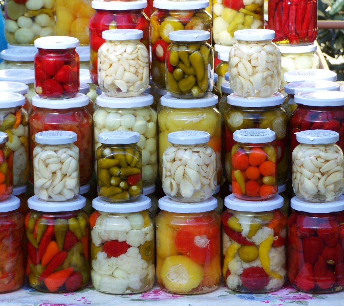 A colorful assortment of pickled vegetables in jars.