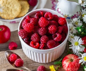 Fresh Red Raspberries in White Dish and Cream Pitcher, Spoons, Cookies, and White Flowers